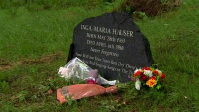 Memorial stone in Ballyatrick forest to Inga Maria Hauser. Bouquets of flowers have been placed around the stone