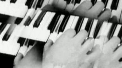 An image of a hand on a keyboard is reflected as if seen through a kaleidoscope.