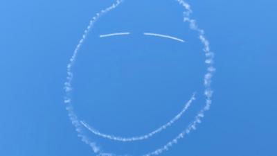 Smiley face drawn in sky by plane vapour trail.