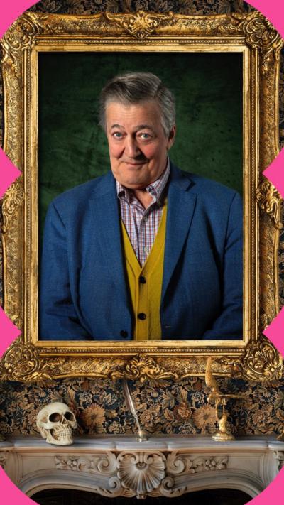 A portrait of Stephen Fry - in a blue suit jacket, yellow cardigan and checked shirt - is in a gold frame on a wall