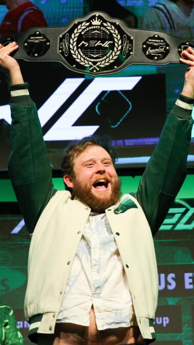 A person holding up the Microsoft Excel world championship belt