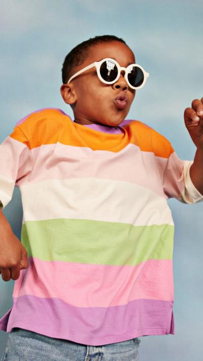 Boy with sunglasses and colourful t-shirt in the sun