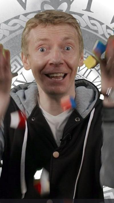 Presenter James Grime throwing a bunch of coloured wooden blocks in the air