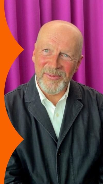 James Reed, pictured wearing a black workcoat over a white shirt - he is an older man with a white beard 