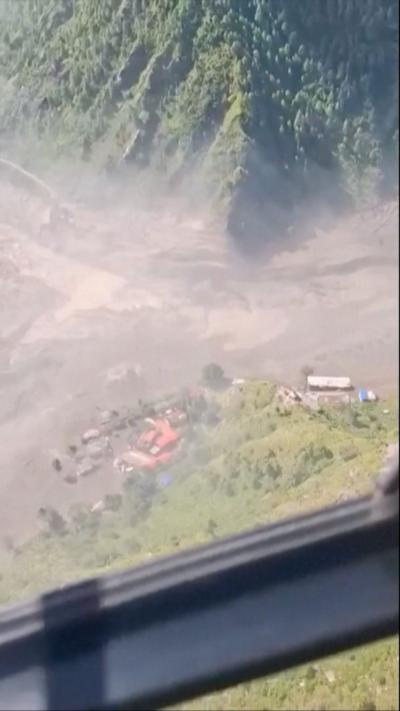 Aerial view of flooded area with houses seen in distance
