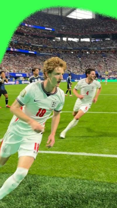Anthony Gordon running to the crowd to celebrate scoring first England goal against Argentina in 2026 World Cup semis.