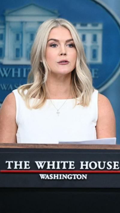 Karoline Leavitt in front of a White House podium