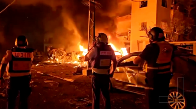 Vehicles set alight following an Iranian missile strike in Haifa