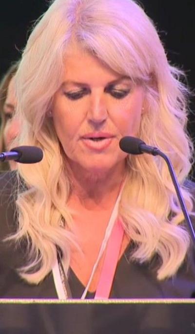 Returning officer speaks into microphone