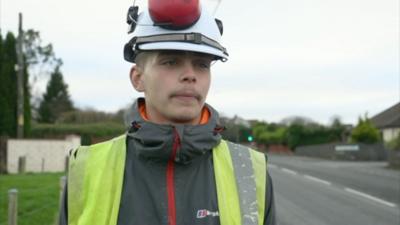 man in high vis vest and helmet