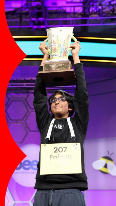 Faizan lifts spelling bee trophy above his head