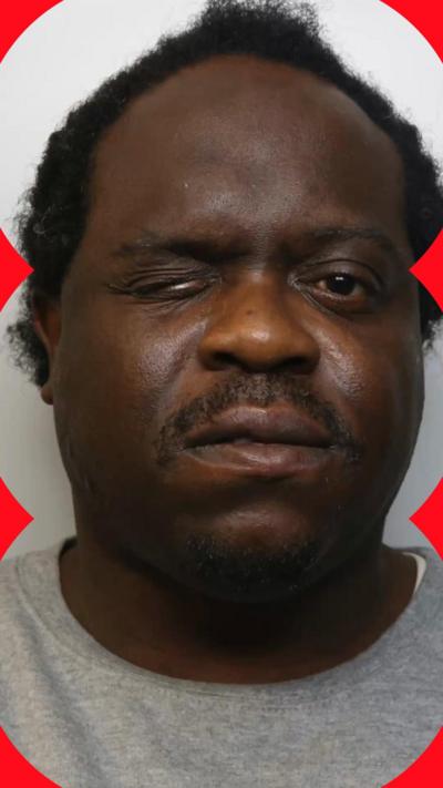 A man squinting one eye in a close-up portrait.