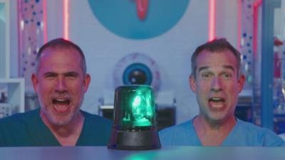 Dr Xand and Dr Chris shout in behind a flashing light