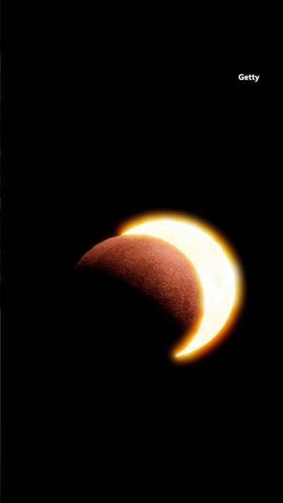 The moon moving in front of the sun in the night sky. 