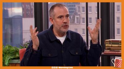 Dr Xand with his hands in the air 