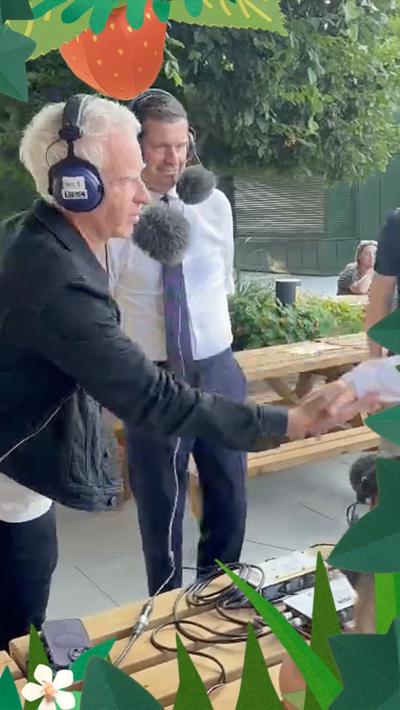 John McEnroe shakes hands with Arthur Fery at Wimbledon