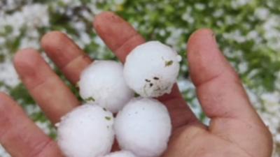Huge hailstones in someone's hand