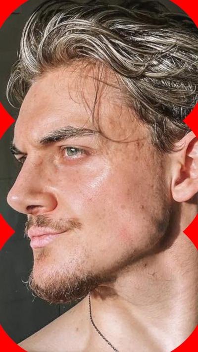 Marvin, a young man looking to the side with a defined jaw, wavy hair and some facial hair