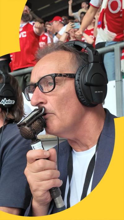 5 Live commentator, Pat Nevin, speaks into the microphone with concentration after Arsenal score within seconds of kick-off at the Community Shield against Man City. 