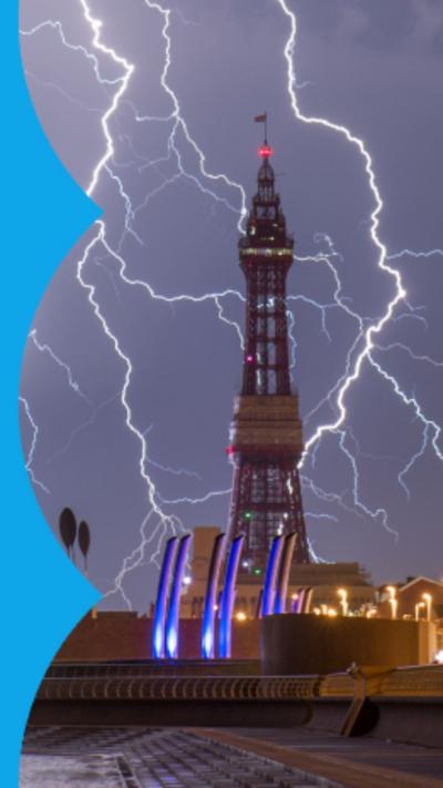 Blackpool Tower surrounded by strikes of lighting at night.