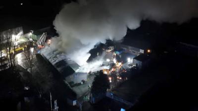 Drone footage of smoke in an industrial estate