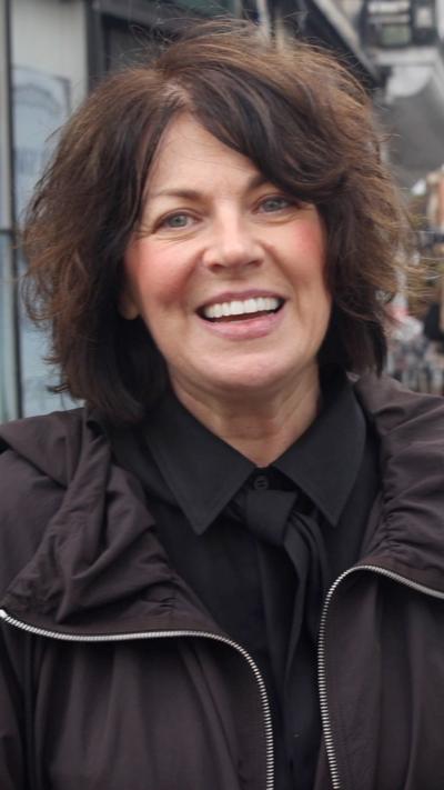 Woman in black shirt and tie and black coat who says she is Sarah Mullally's niece