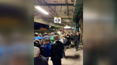 Passengers stand on the platform at Pontypridd train station