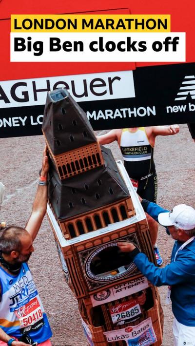 Lukas Bates struggle to cross the finish line dressed as Big Ben