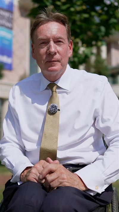 Frank Gardner in a white shirt with a gold tie