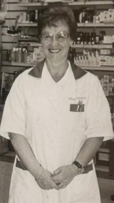 Black and white image of Sadie in her white pharmacist's uniform. 