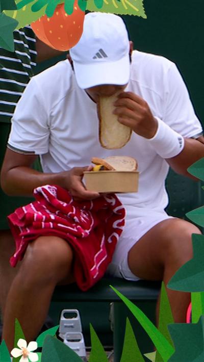 Learner Tien sitting down and eating a slice of bread