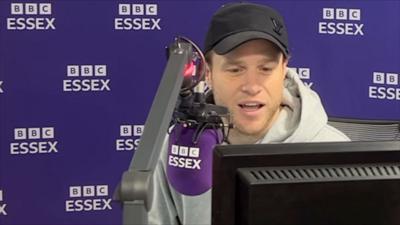 Olly Murs speaking into a BBC Essex microphone.