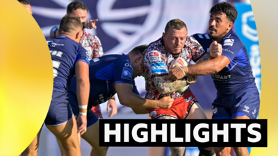 Leigh Leopards' Josh Charnley is tackled by Toulouse's Anthony Marion and Maxime Stefani
