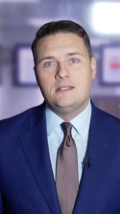 Wes Streeting in a navy suit and brown tie