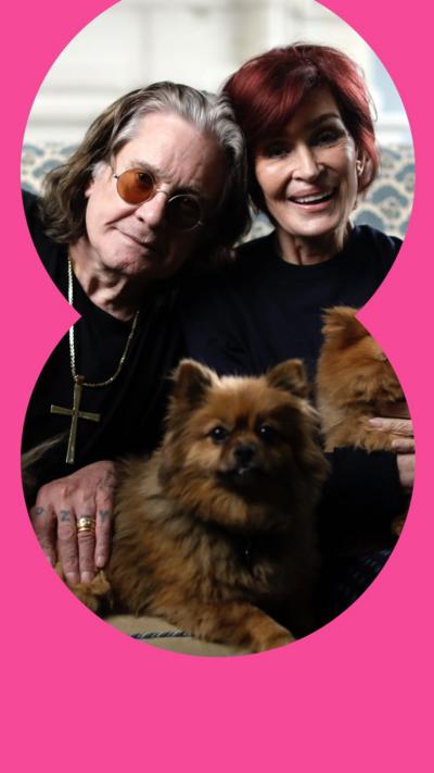 Couple Ozzy and Sharon Osbroune holding two dogs on their lap 