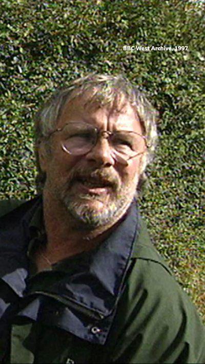 A man looking at the camera with glasses on.