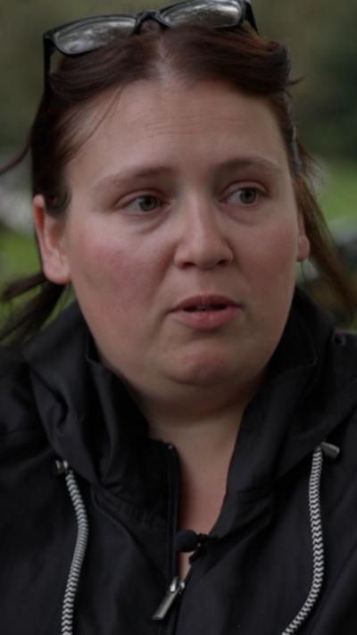 Close-up of woman with dark hair wearing black jacket