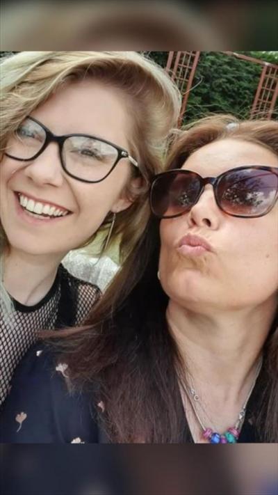 A selfie of a young blonde girl and an older woman with dark hair and sunglasses on.