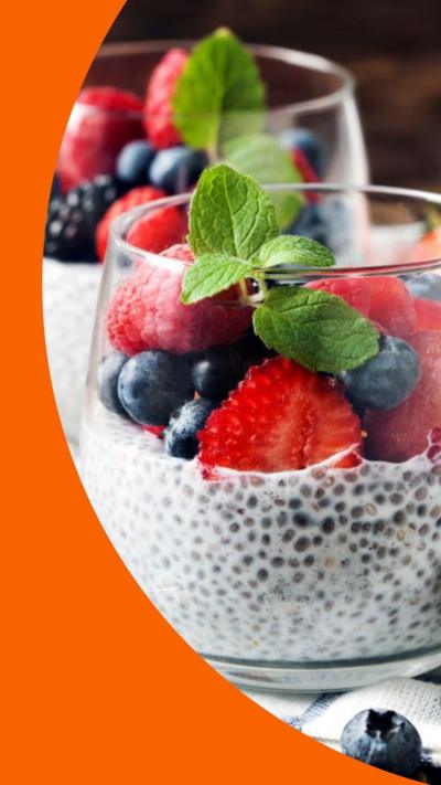 Two glass cups with chia seed pudding and fresh berries inside them