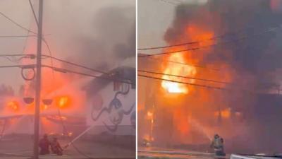 Firefighters are hosing down a building that caught on fire.