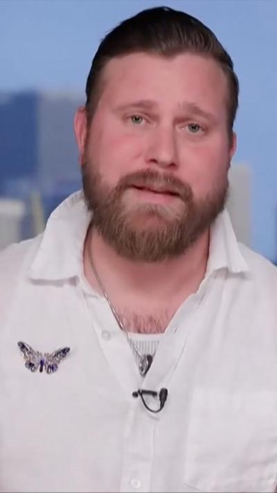 Sky Roberts, wearing a white shirt