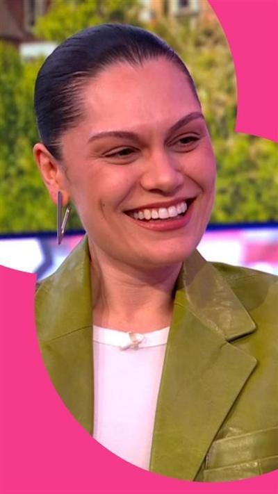 Jessie J is wearing a green leather jacket with wide shoulders. Her hair is slicked back.