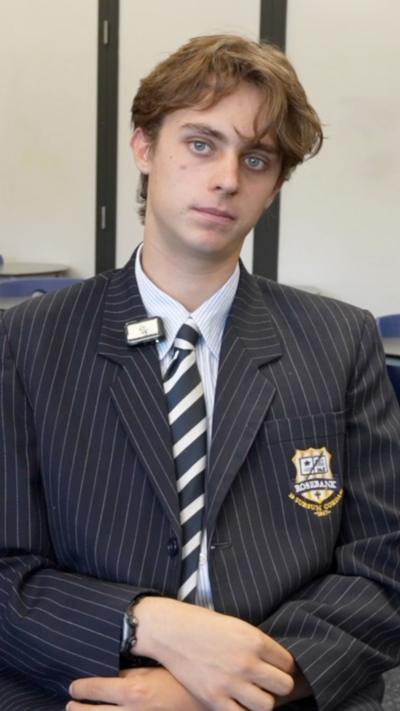 Tyson, 15, wears pin-stripped blazer school uniform