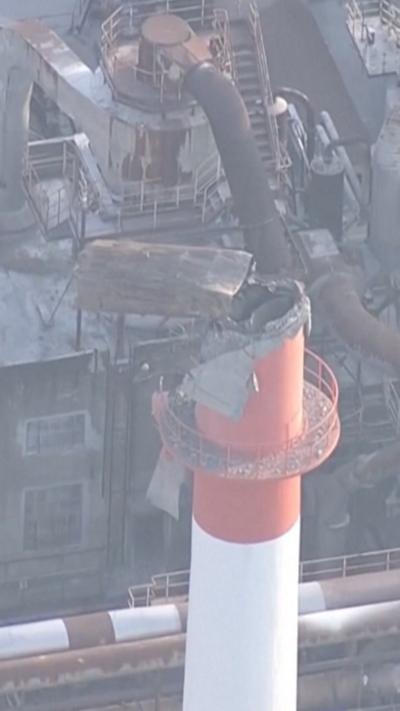 Collapsed chimney on top of a factory.