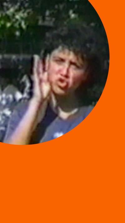 A deaf student using sign language while outdoors