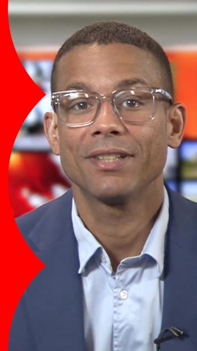 Daniel Kebede during studio interview wearing navy blazer and light blue shirt