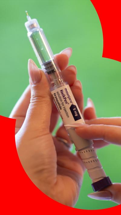 A woman's hands hold an injection needle containing the weight-loss drug Mounjaro.