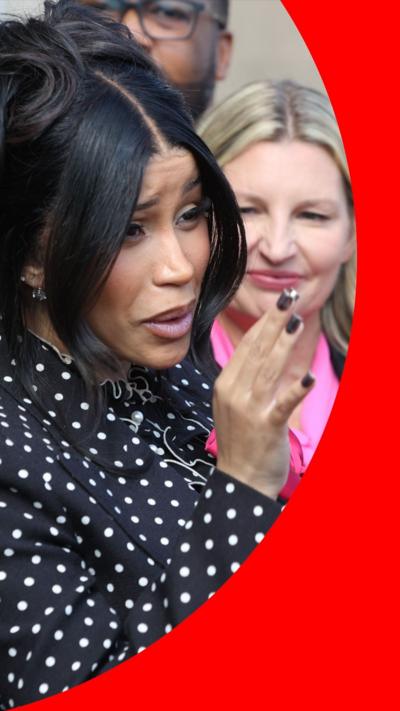 Cardi B speaks to reporters outside court. She has black hair tied up and wears a black top with white polka dots