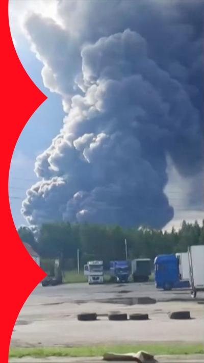 Huge plume of dark smoke rises from the horizon