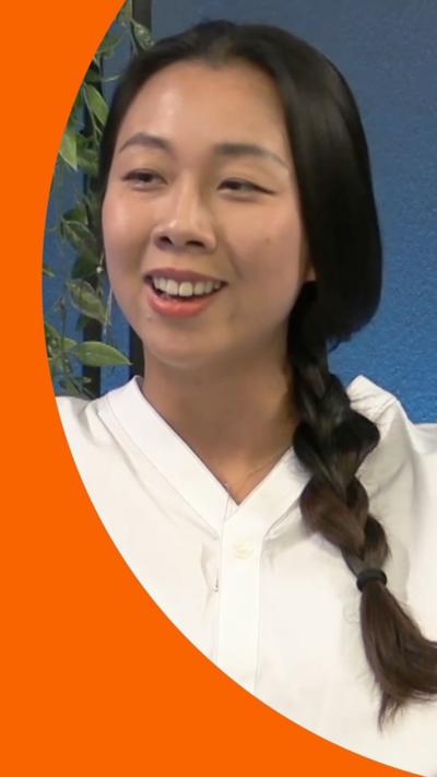 Journalist Mengchen Zhang speaks during the podcast. She has long black hair in a pigtail and wears a white top